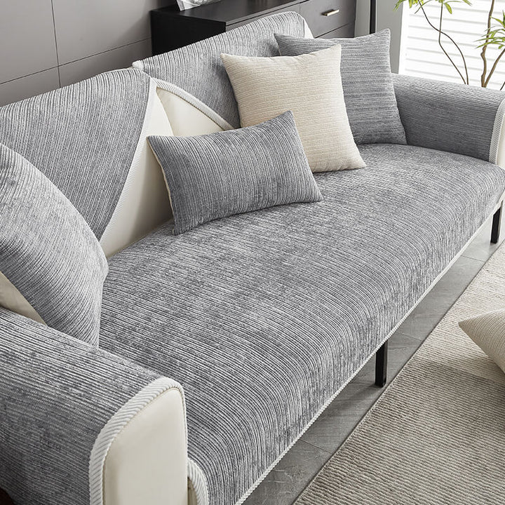 Demonstrating the anti-scratch durability of the striped chenille sofa cover. Perfect for homes with pets.