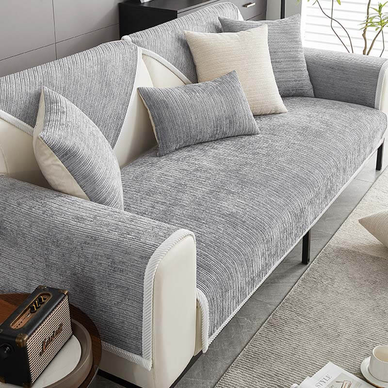 View of the striped chenille sofa slipcover, a pet-friendly and washable furniture protector for families.