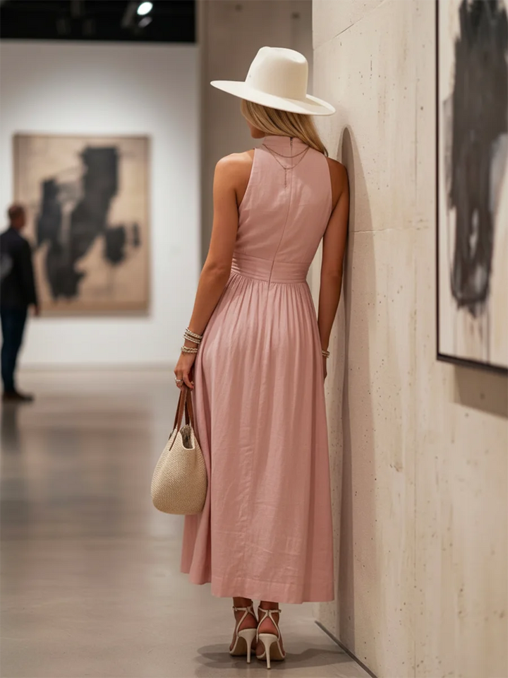Side view of pink boho maxi dress, highlighting gathered waist & flowy skirt. Halter V-neck women's summer fashion.