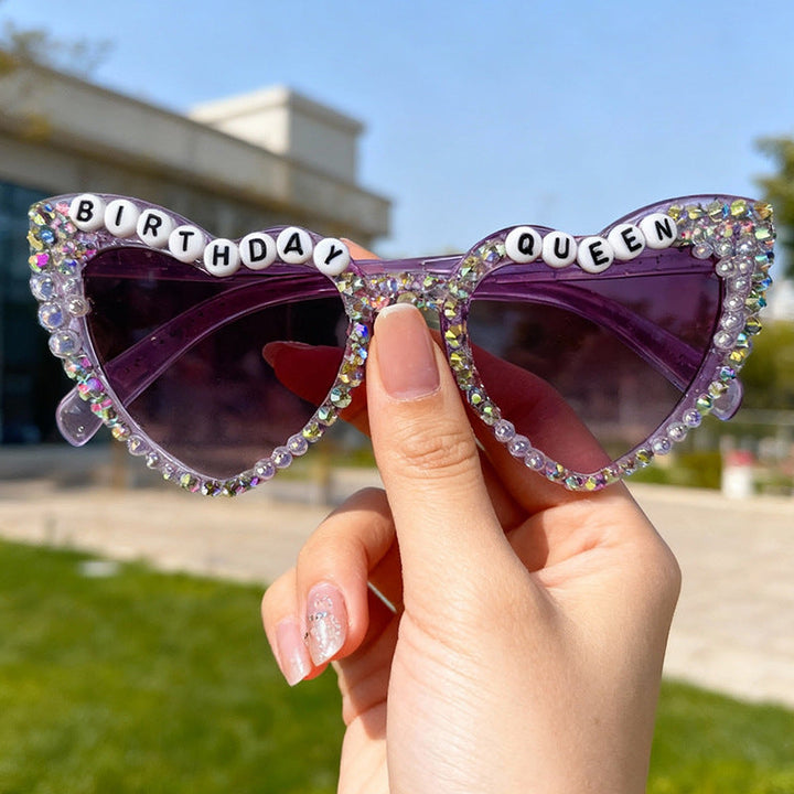 Sparkling purple heart-shaped sunglasses for women, a glam accessory for any birthday party.
