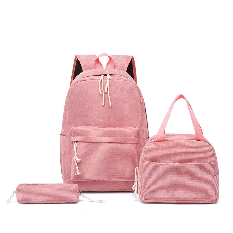Happy girl wearing a playful pink strawberry school backpack, ready for adventures & learning.