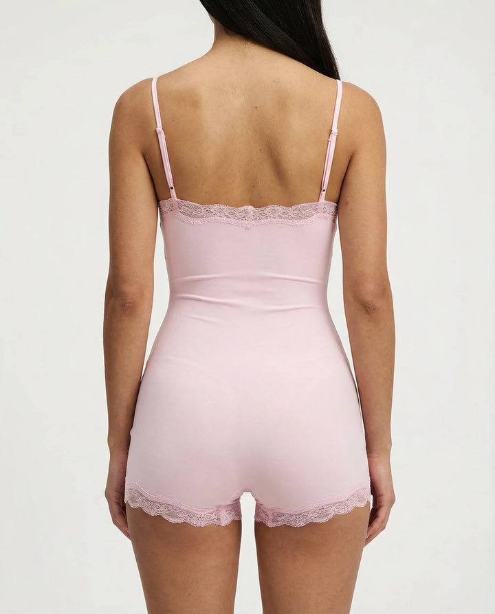Black elegant stretch cami romper with delicate lace trim. Feminine nightwear for ultimate comfort.