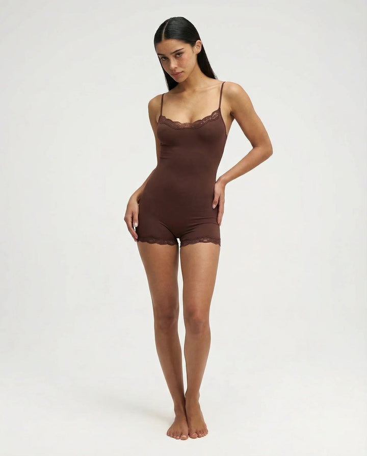 Elegant women's lace trim cami romper in pink. Ultimate comfort sleepwear, versatile loungewear.