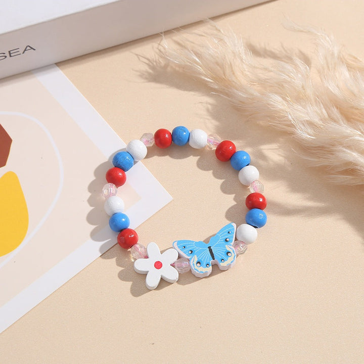 Girls' & women's playful pink charm bracelet, crafted with wooden beads, heart & butterfly accents.