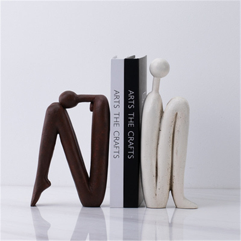 Playful figurine bookends in unique, modern design, perfect for stylish home decor, office, or bookshelf organization.