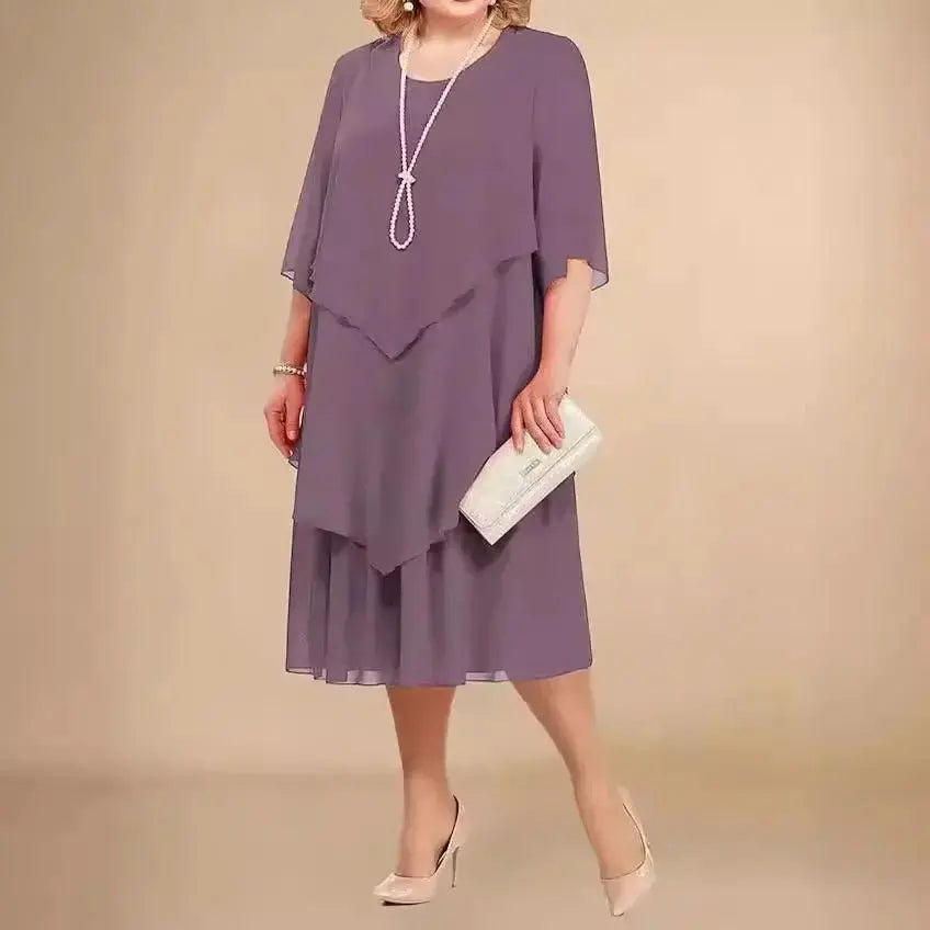 Elegant women's plus size layered midi dress with asymmetrical hem. Ideal as a formal or wedding guest dress.