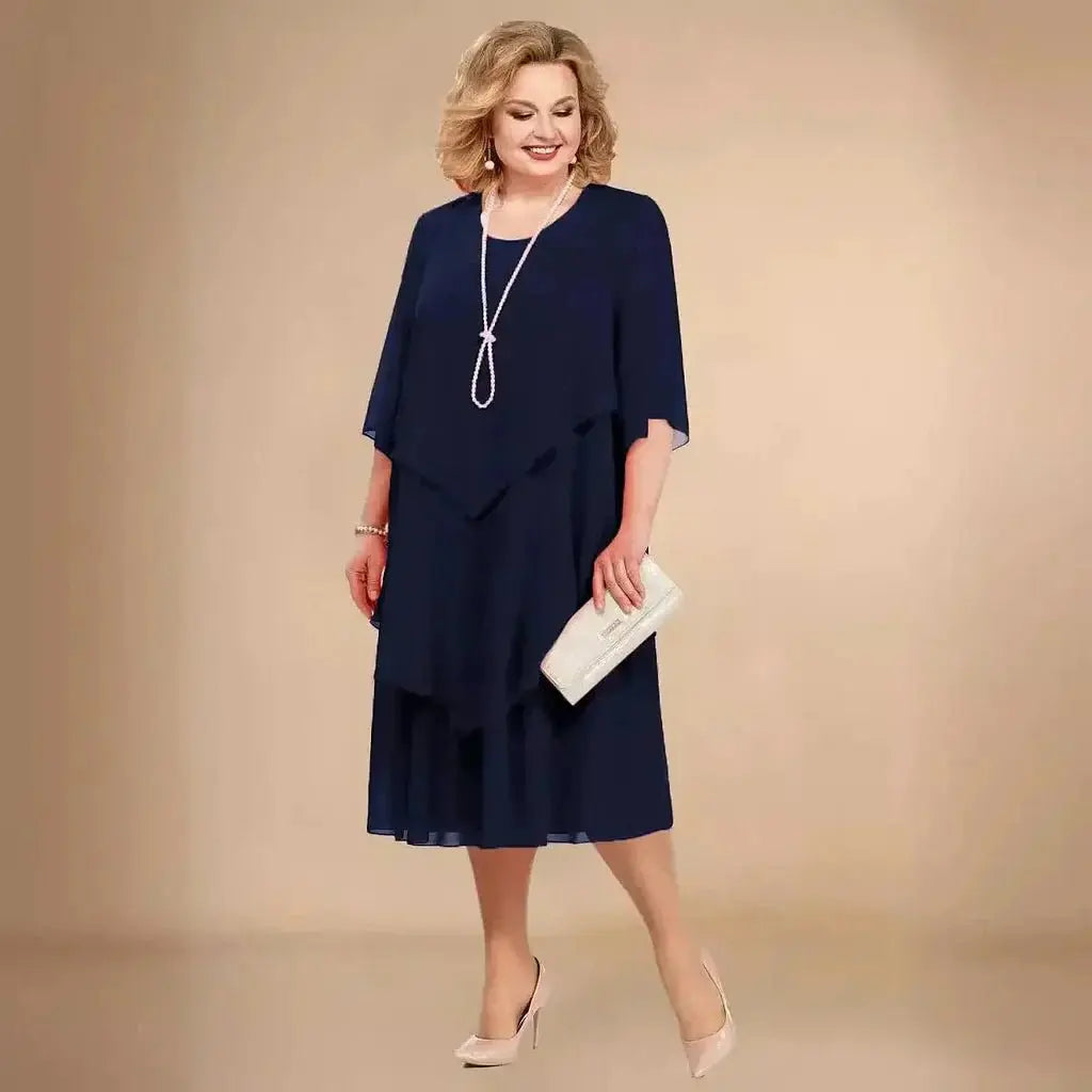 Chic plus size women's midi dress, featuring an asymmetrical layered design for a comfortable, elegant evening look.