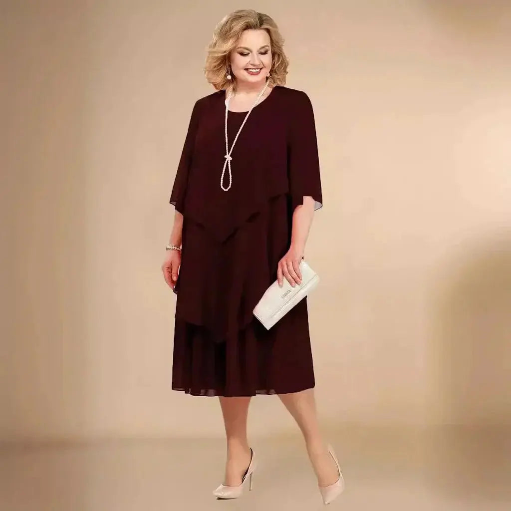 Black plus size women's formal midi dress, with unique asymmetrical layering and flattering silhouette.