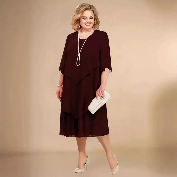 Black plus size women's formal midi dress, with unique asymmetrical layering and flattering silhouette.