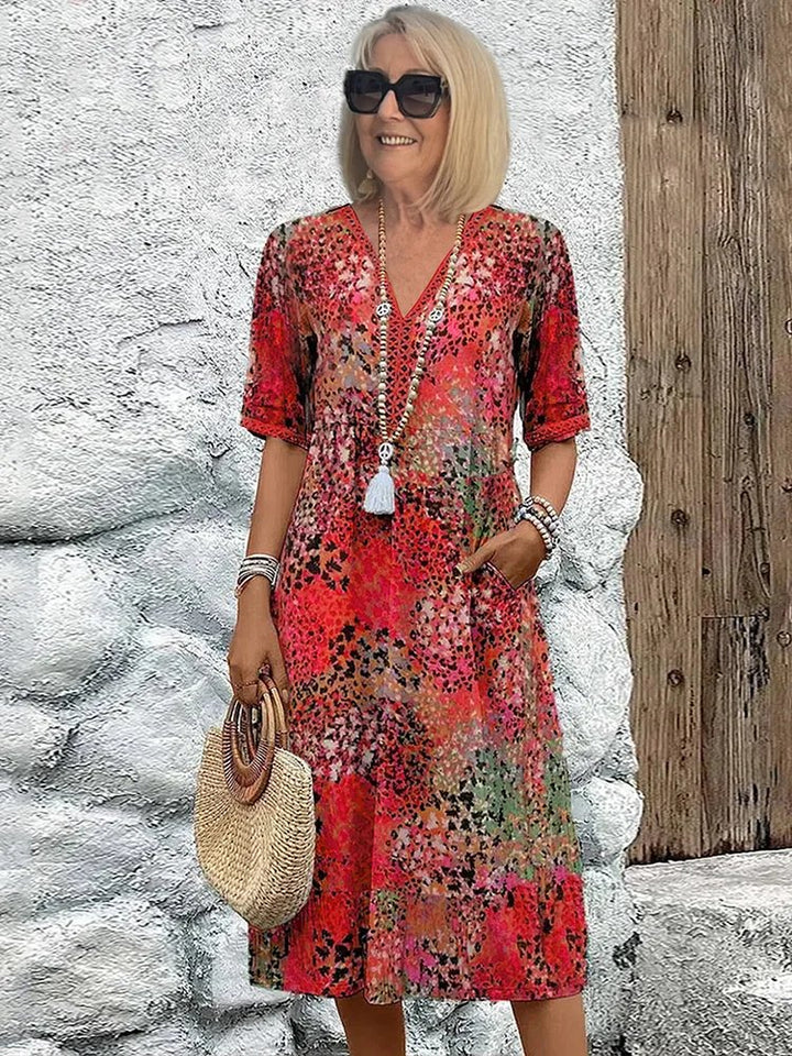 Plus size floral V-neck midi dress with pockets for women, perfect for summer casual wear.