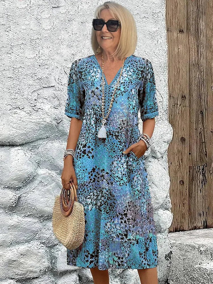 Elegant plus size women's floral print midi dress, V-neck, pockets, ideal for spring vacation or casual outings.