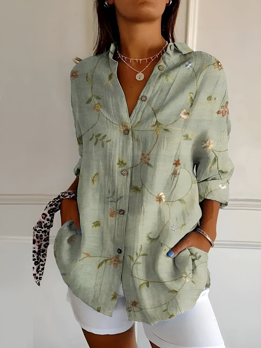 Stylish plus size women's blue floral long sleeve button-up shirt, a versatile top for extended sizes.