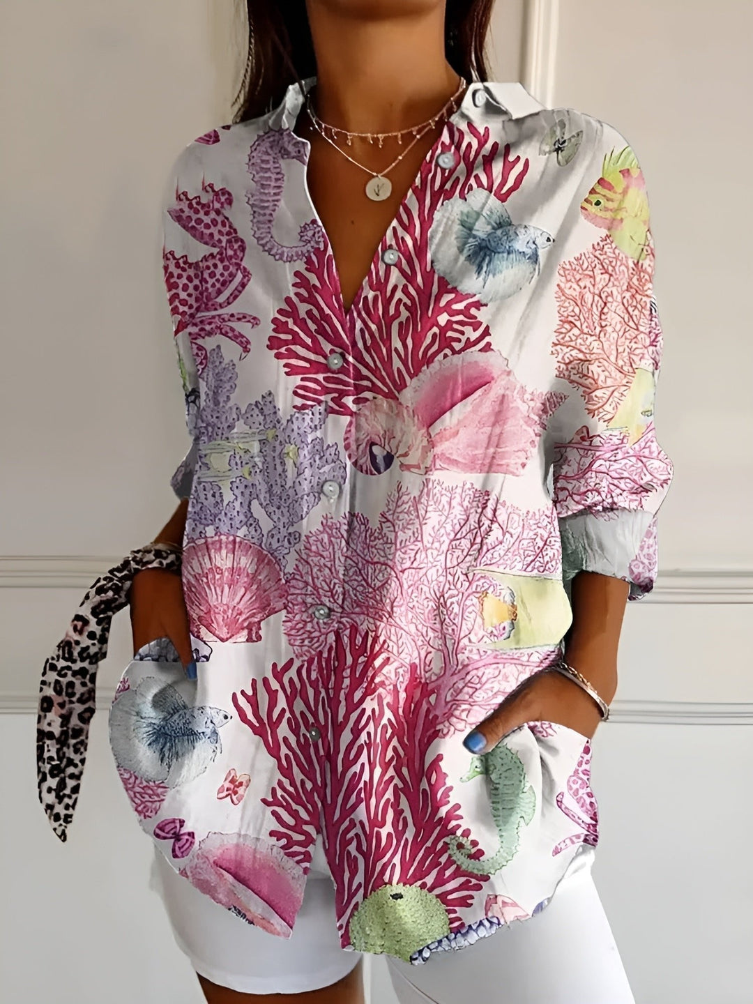 Close-up of vibrant blue floral print on a women's plus size long sleeve button-up shirt fabric.
