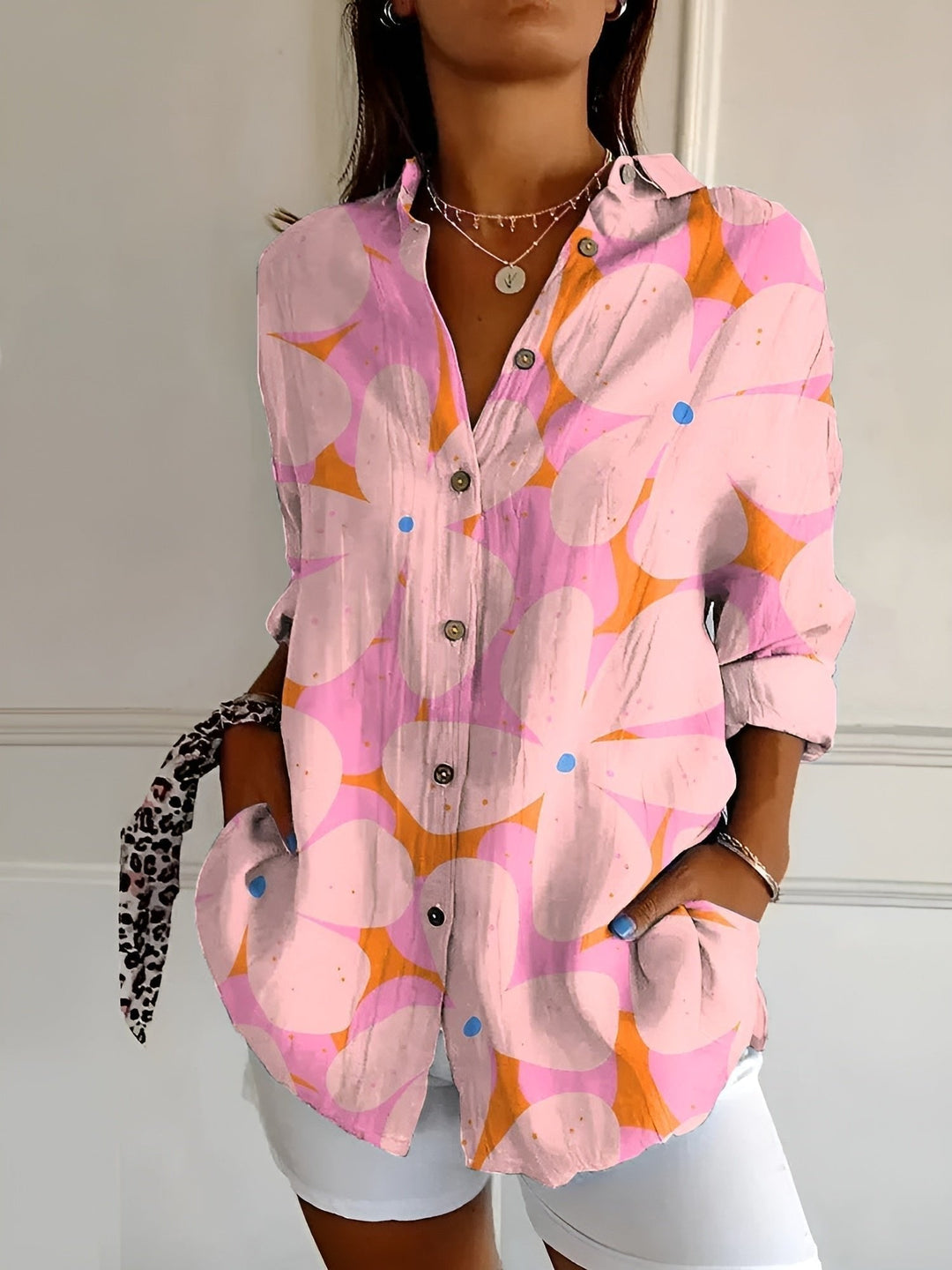 Full view of a women's plus size blue floral long sleeve button-up shirt, ideal casual blouse.