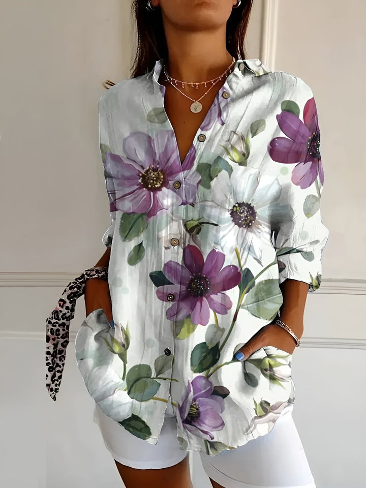 Detailed view of buttons and cuffs on a women's plus size blue floral long sleeve button-up shirt.