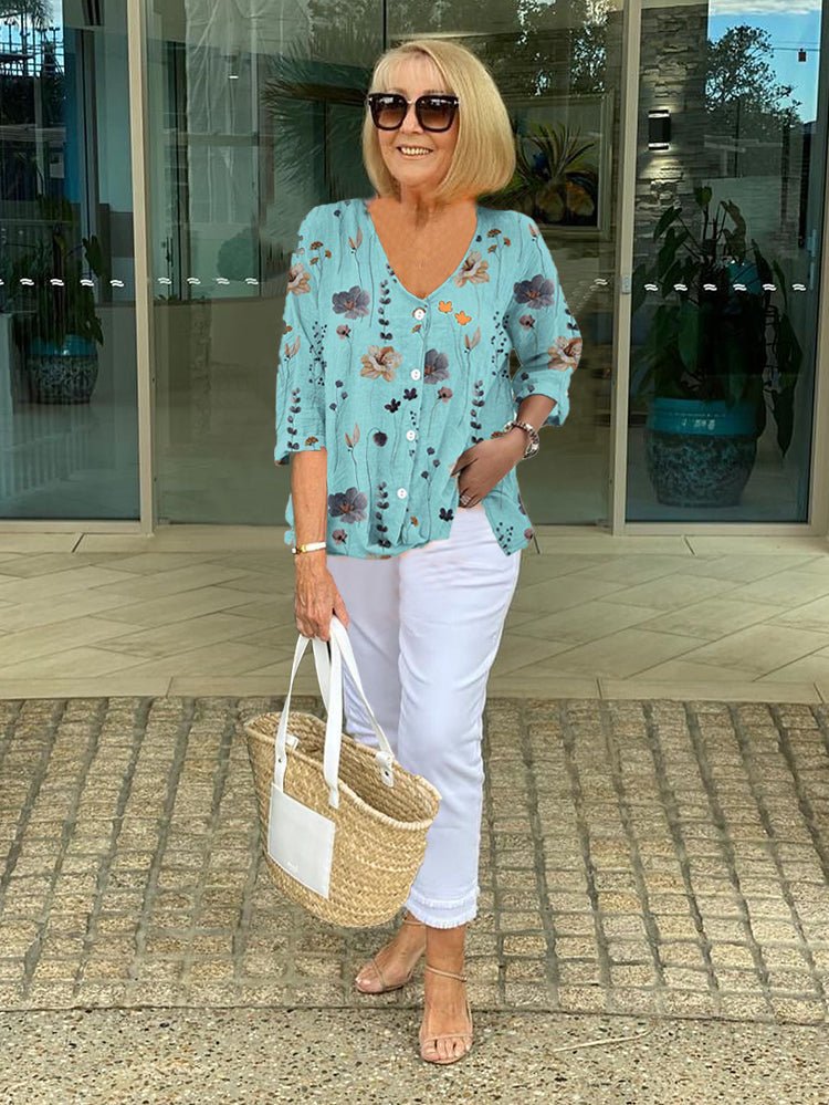 Plus size women's floral print blouse with a flattering V-neck and stylish 3/4 sleeves. Relaxed fit top.