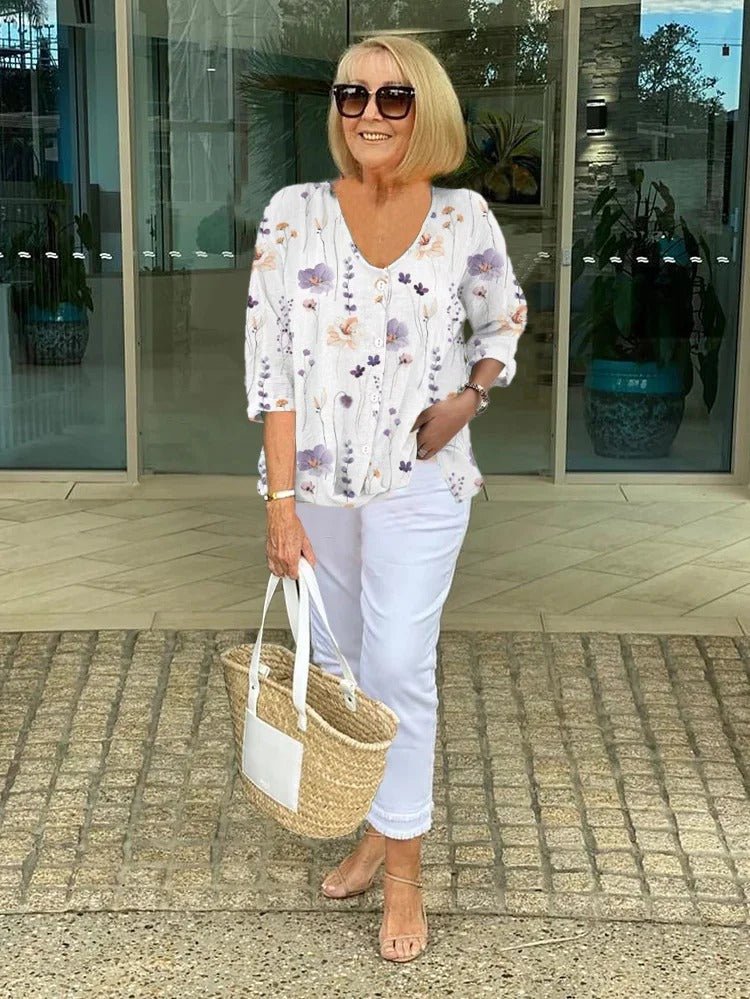 Women's plus size floral blouse featuring a V-neck, 3/4 sleeves, ideal for everyday or workwear. Relaxed fit.