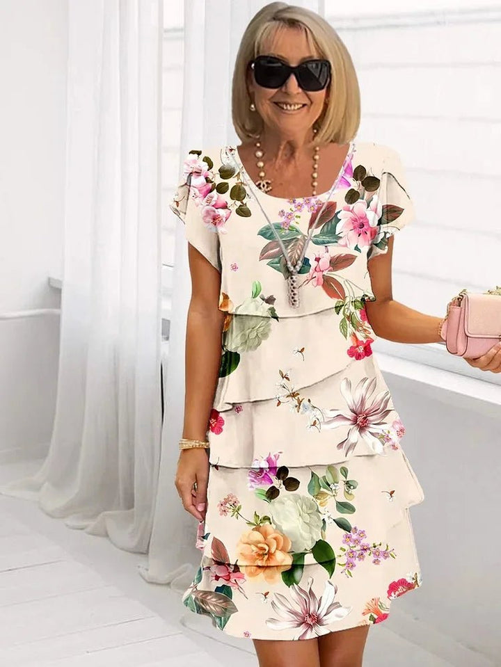 Elegant plus size women's ruffled midi dress with delicate floral pattern and stylish short sleeves.