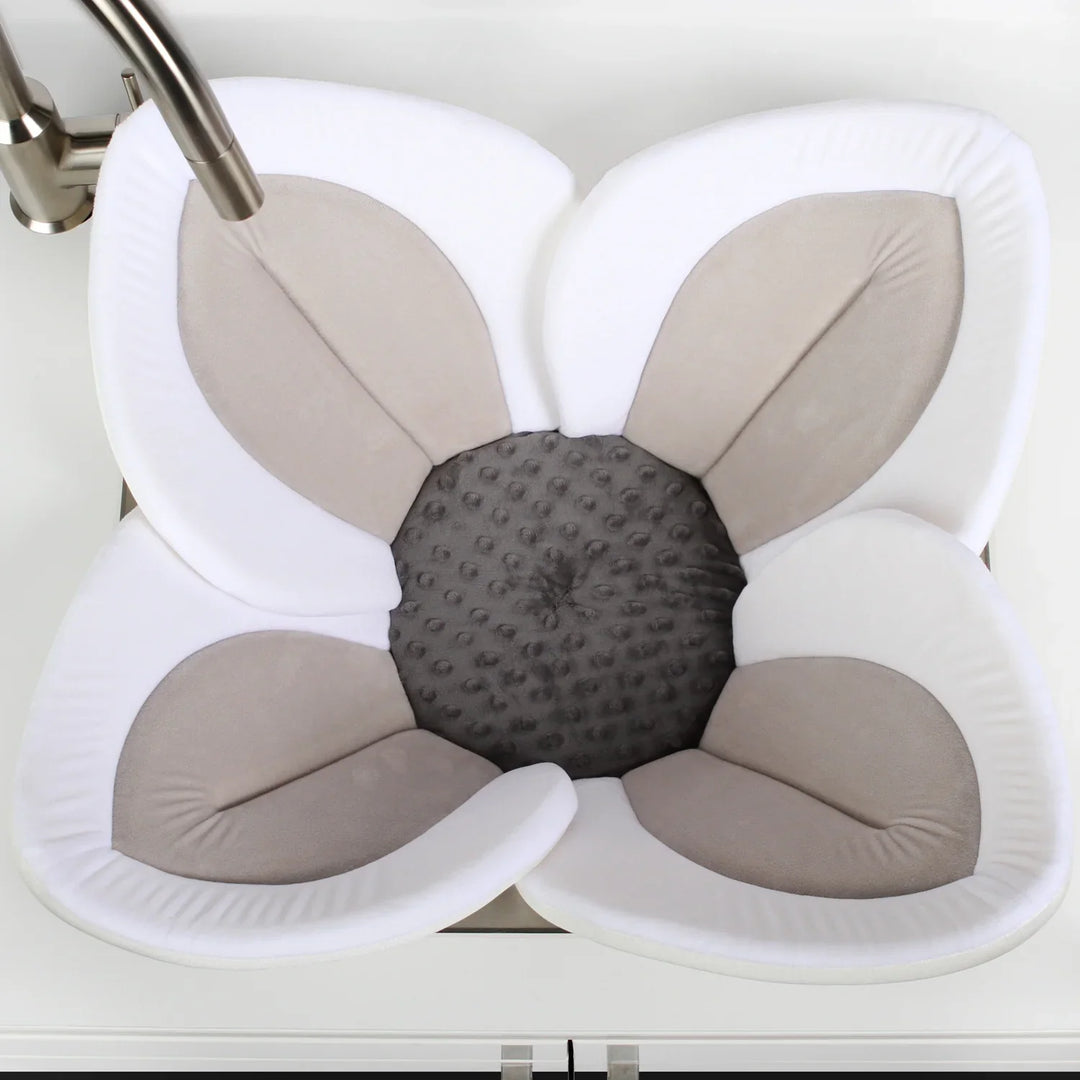 Soft plush flower baby bath seat for newborns. Machine washable infant sink bath support for easy care.