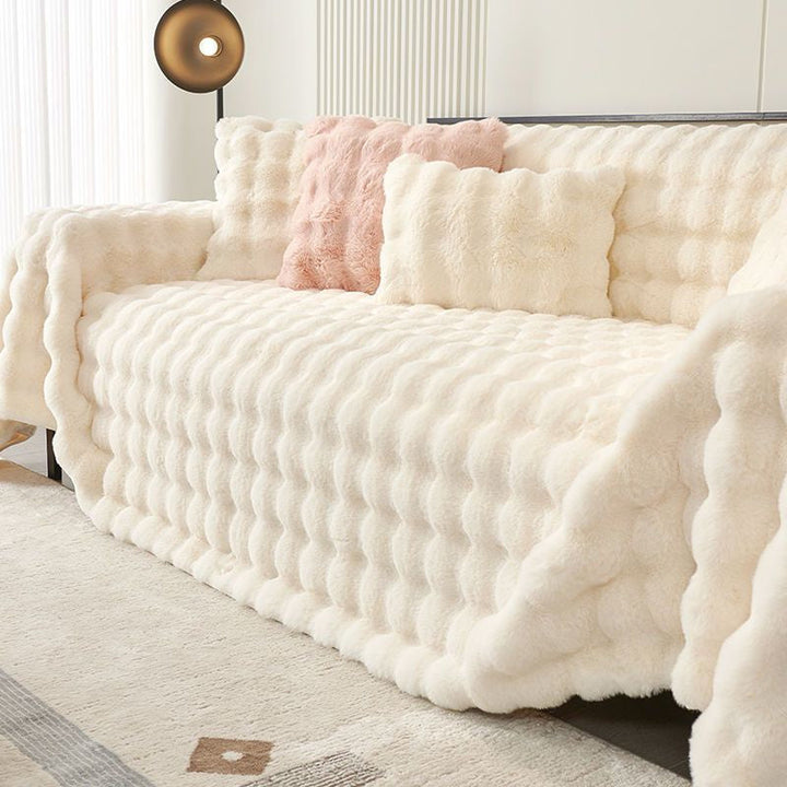 Plush cream white faux fur sofa cover, non-slip, for elegant living room decor & furniture protection.