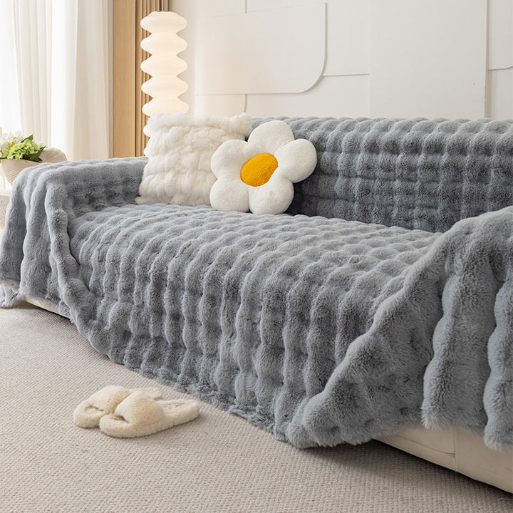 Dark gray plush faux fur sofa blanket, non-slip, a cozy and pet-friendly addition to home decor.