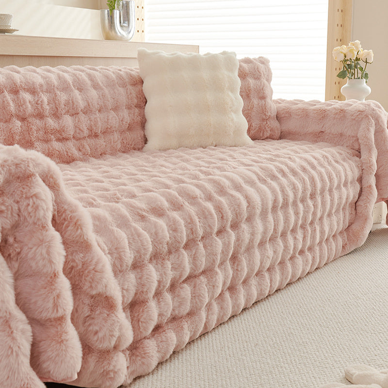 Cream white non-slip faux fur sofa throw, luxurious and soft, ideal for stylish home protection.
