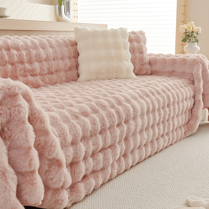 Cream white non-slip faux fur sofa throw, luxurious and soft, ideal for stylish home protection.