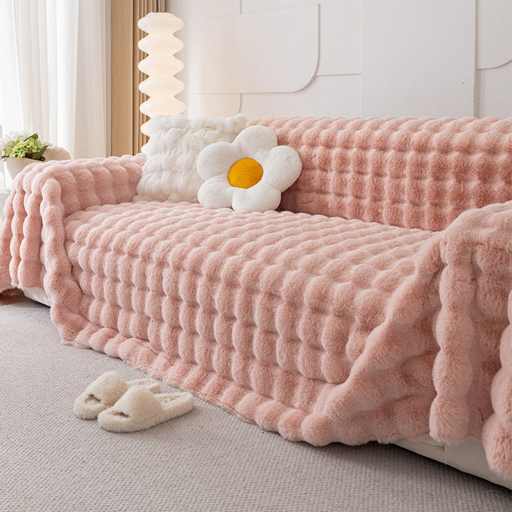 Khaki faux fur sofa protector, non-slip, offers plush comfort and modern living room decoration.