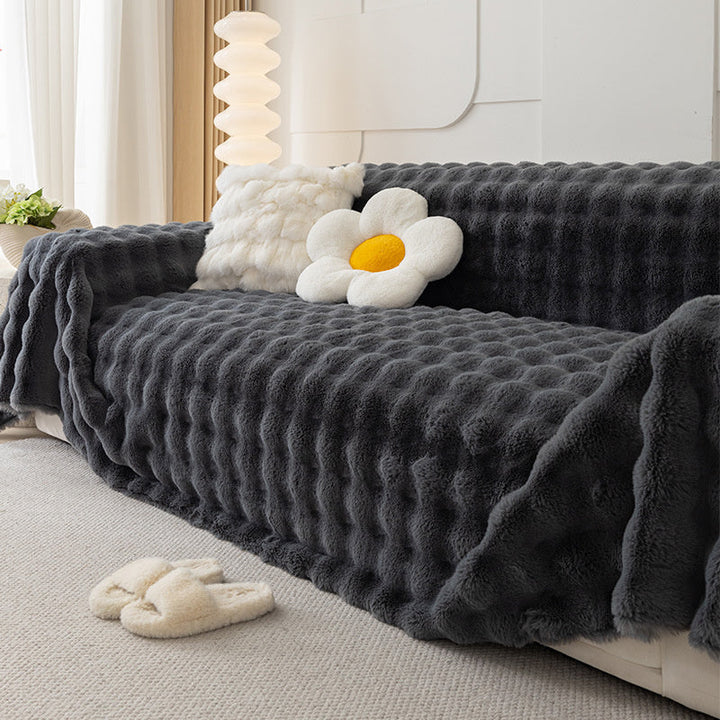 Light gray cozy faux fur sofa cover, non-slip, elegant home textile for furniture protection.