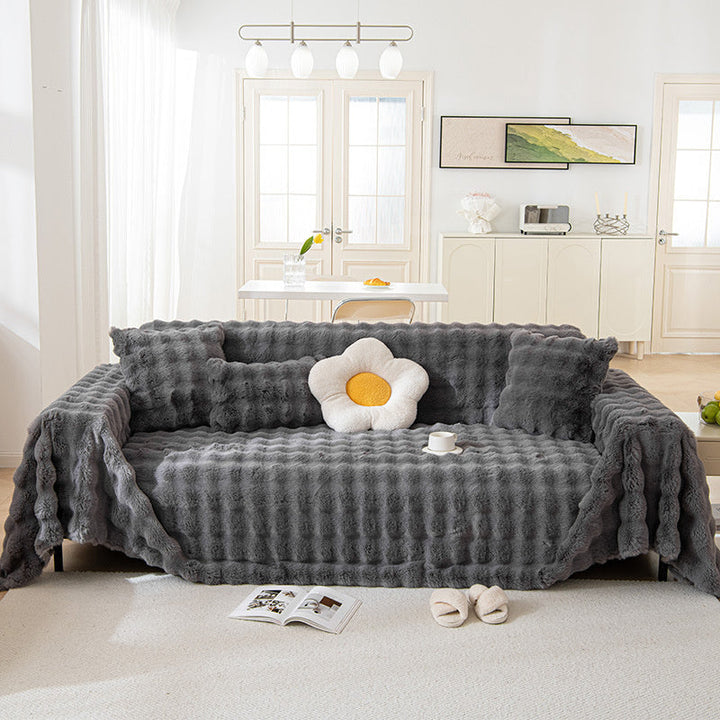 Dark gray plush non-slip sofa cover, faux fur for ultimate comfort, elegant & pet-friendly.