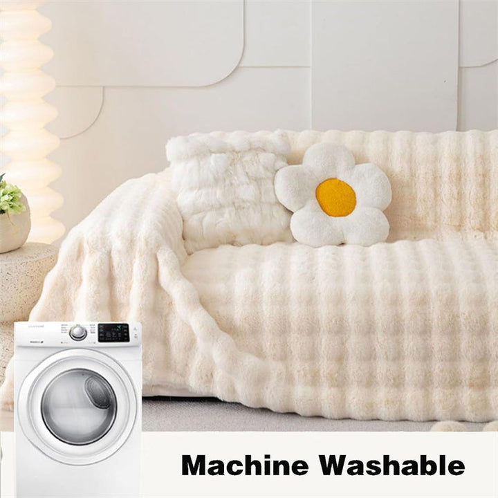 Cream white plush faux fur couch cover, non-slip, elegant and pet-friendly living room accent.