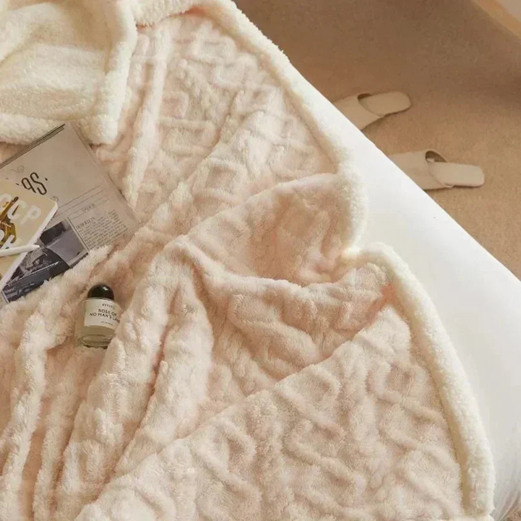 Close-up of a plush heavy knit wool blend throw blanket, highlighting its soft and inviting texture.