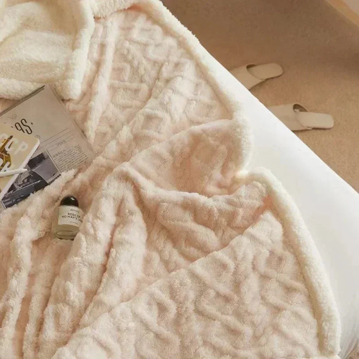 Close-up of a plush heavy knit wool blend throw blanket, highlighting its soft and inviting texture.
