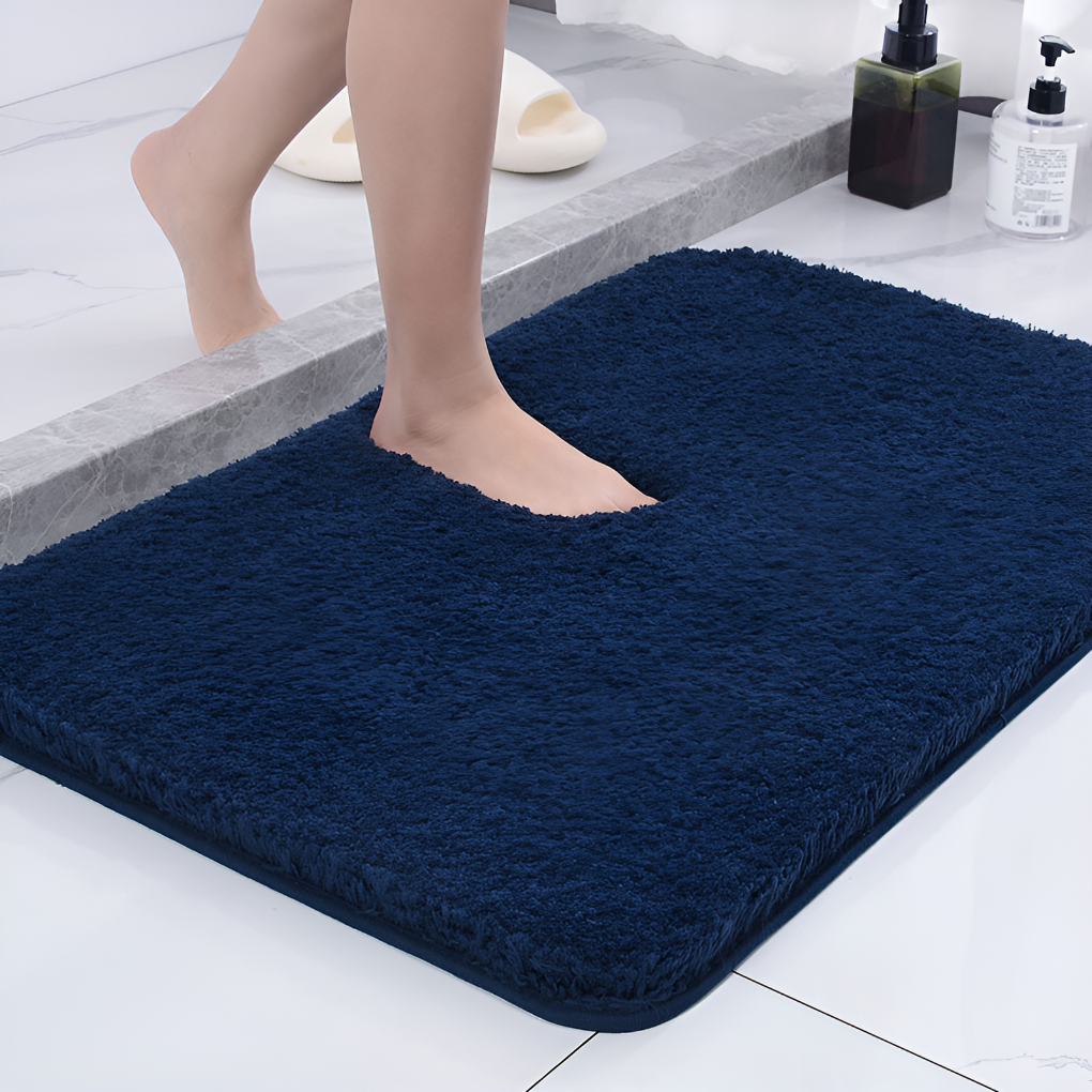 Thick, plush microfiber bath mat in a neutral color, offering soft comfort and absorbent qualities.