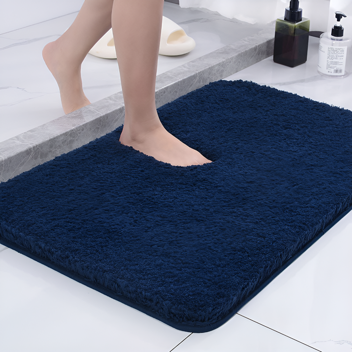 Thick, plush microfiber bath mat in a neutral color, offering soft comfort and absorbent qualities.