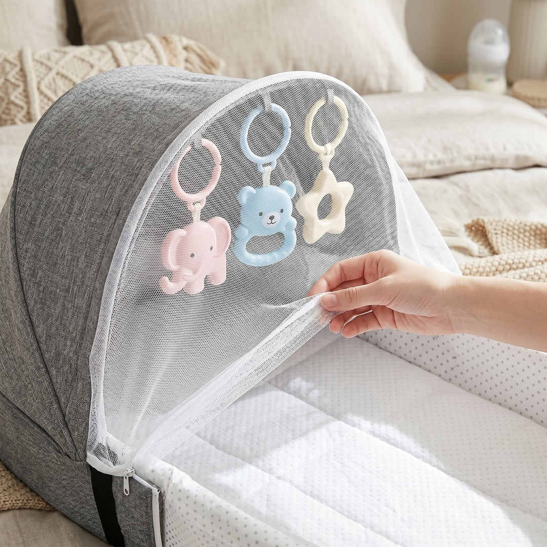 Lightweight baby travel net bed, easy pop-up design for quick setup & portable infant sleep solution.