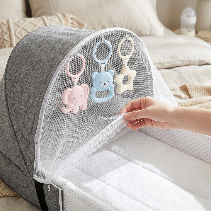 Lightweight baby travel net bed, easy pop-up design for quick setup & portable infant sleep solution.