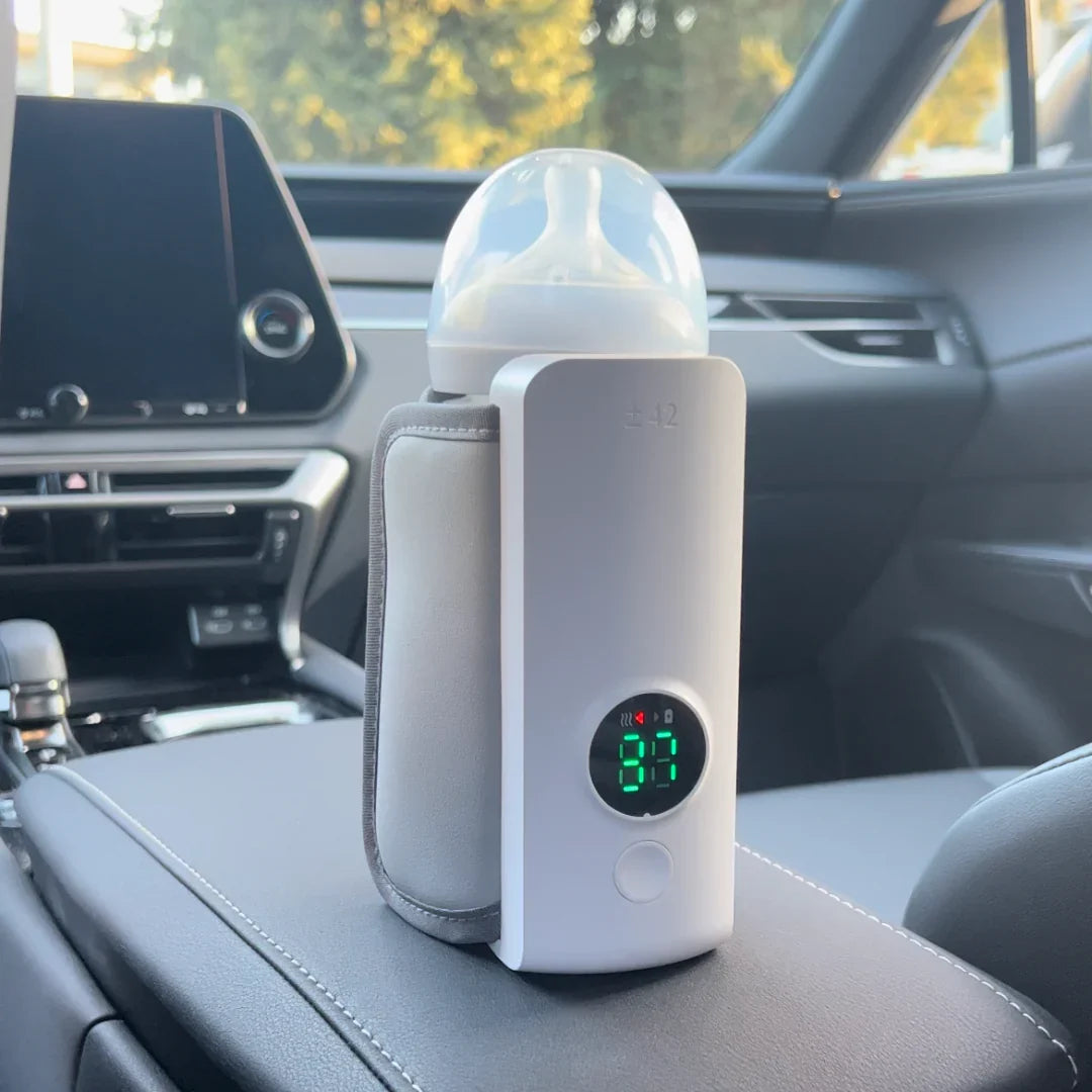 Mom warms baby bottle with portable, rechargeable milk warmer. Ideal for travel & infant comfort.