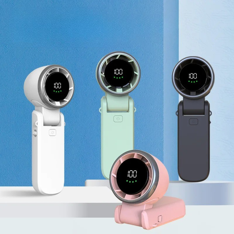 Portable turbo handheld fan in a person's hand, offering instant personal cooling for summer travel.