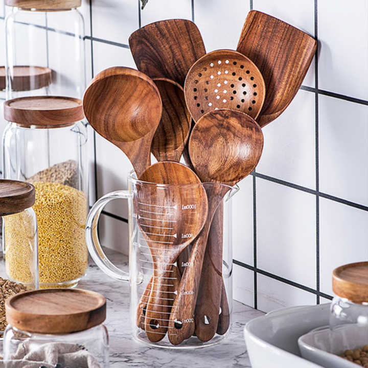 Premium 7-piece natural teak wood kitchen utensil set. Durable, eco-friendly wooden spoons & spatulas for cooking & serving.