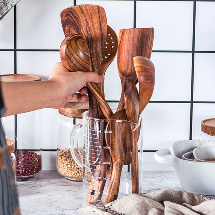 Natural teak wood 7-piece kitchen utensil set. High-quality cooking tools, including wooden spoons, spatulas & serving tools.