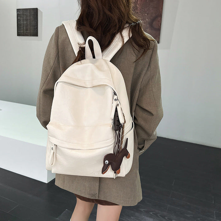 Premium black leather backpack, unisex, with multiple pockets and adjustable straps for daily style and organization.