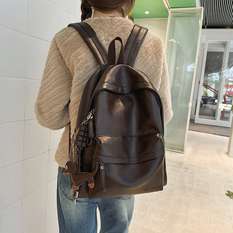 Stylish unisex black leather backpack with front zipper pockets, durable design for work, travel & daily essentials.