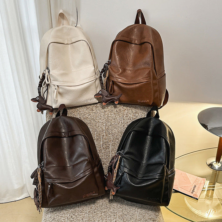 Durable black leather backpack for daily carry, featuring a sleek design & spacious interior, adjustable shoulder straps.