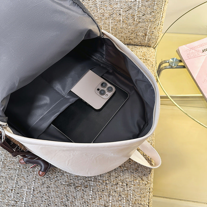 Organized interior of a black leather multi-pocket backpack, perfect for daily essentials, work, and travel gear.
