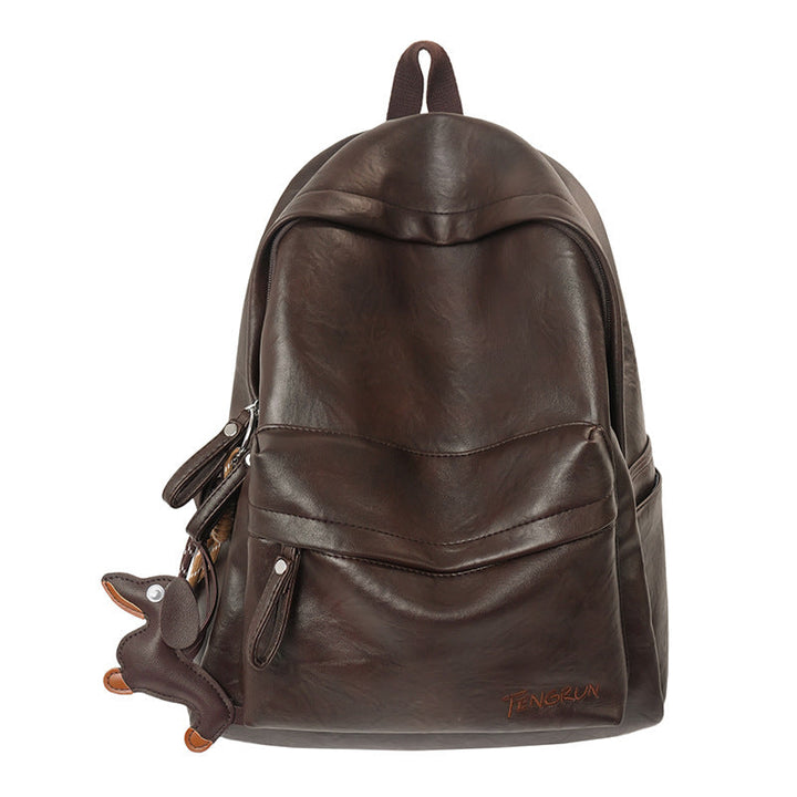 Stylish unisex black leather backpack worn by a person, ideal for urban daily carry, work commute, or travel.