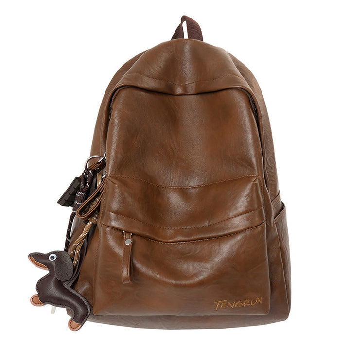Close-up of the premium black leather texture on a durable unisex backpack, highlighting its quality and craftsmanship.