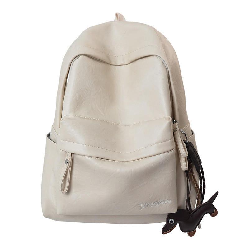 Versatile black leather work backpack with multiple exterior pockets for easy access to daily travel and work items.