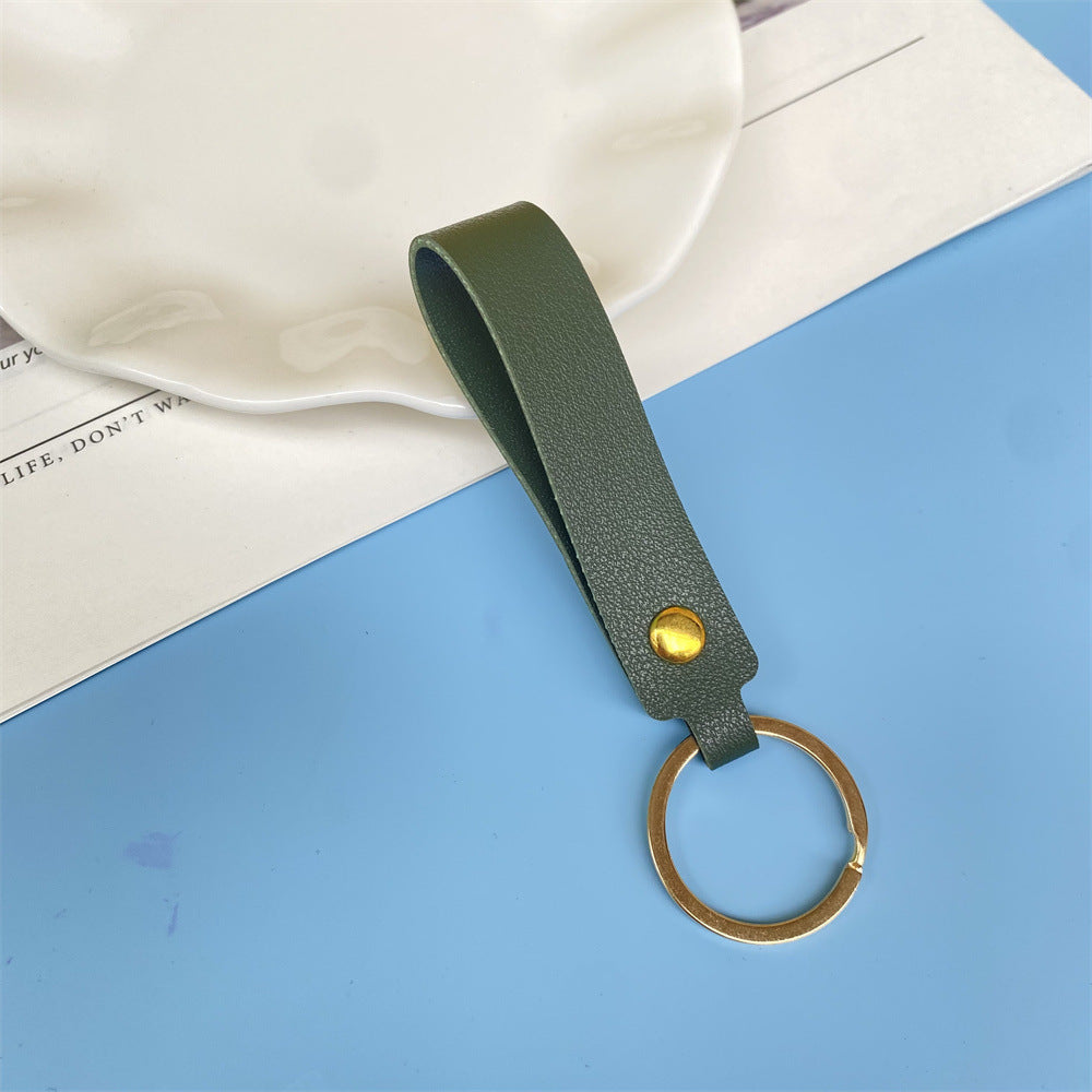 Green leather key fob, simple yet stylish unisex design.