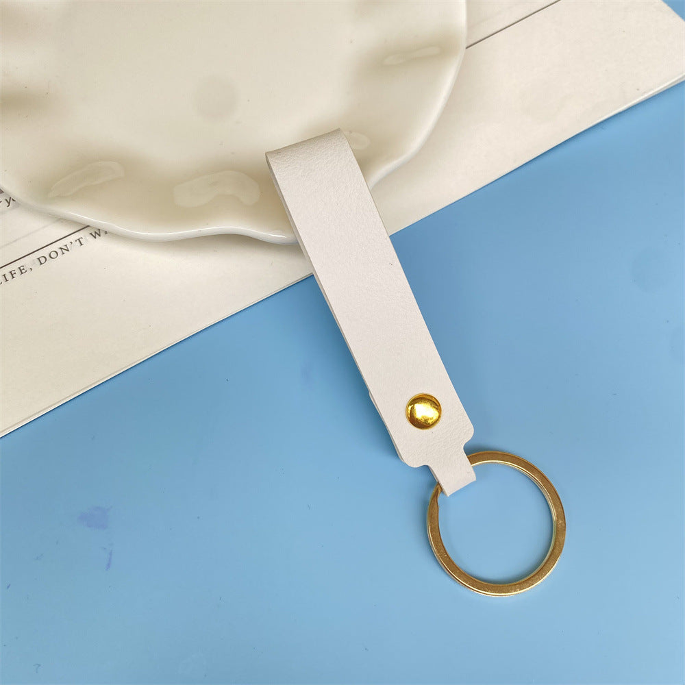 Blue leather key fob, durable & compact for everyday use.